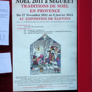 Provence - Expositions des Santons in Seguret - an affiche in a Sablet store window