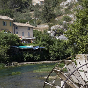 At Fontaine de Vaucluse, the picturesque sight of a Water Wheel with village houses in the background