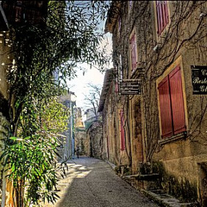 The tall village houses shade the narrow street in Venasque